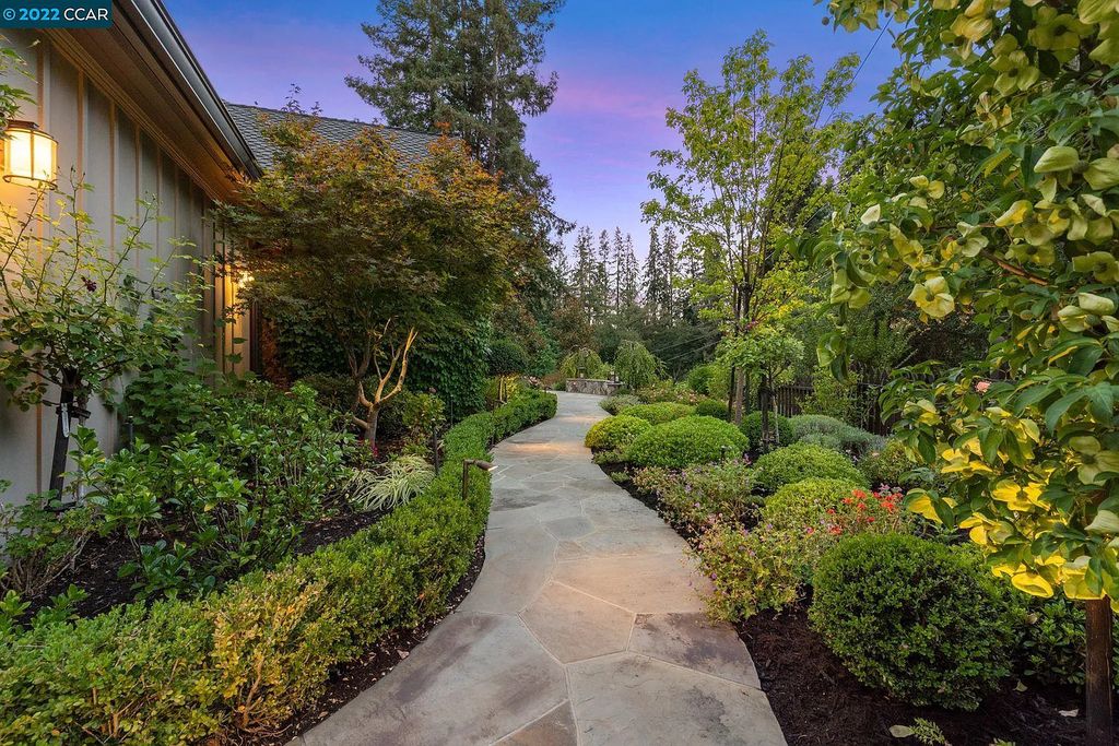 This Happy Valley masterpiece, on a traffic-free cul-de-sac, was built as the personal residence of its noted designer. Outdoor dining areas survey the magnificent terraced garden and adjoin a waterfall feature and firepit.